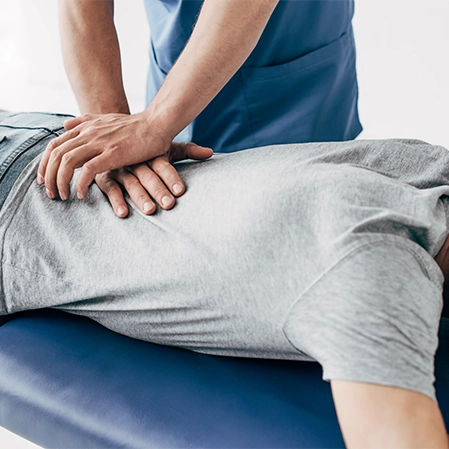 Man Lying Down Receiving Chiropractic Adjustment