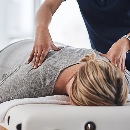 Woman Lying Down Receiving Chiropractic Adjustment